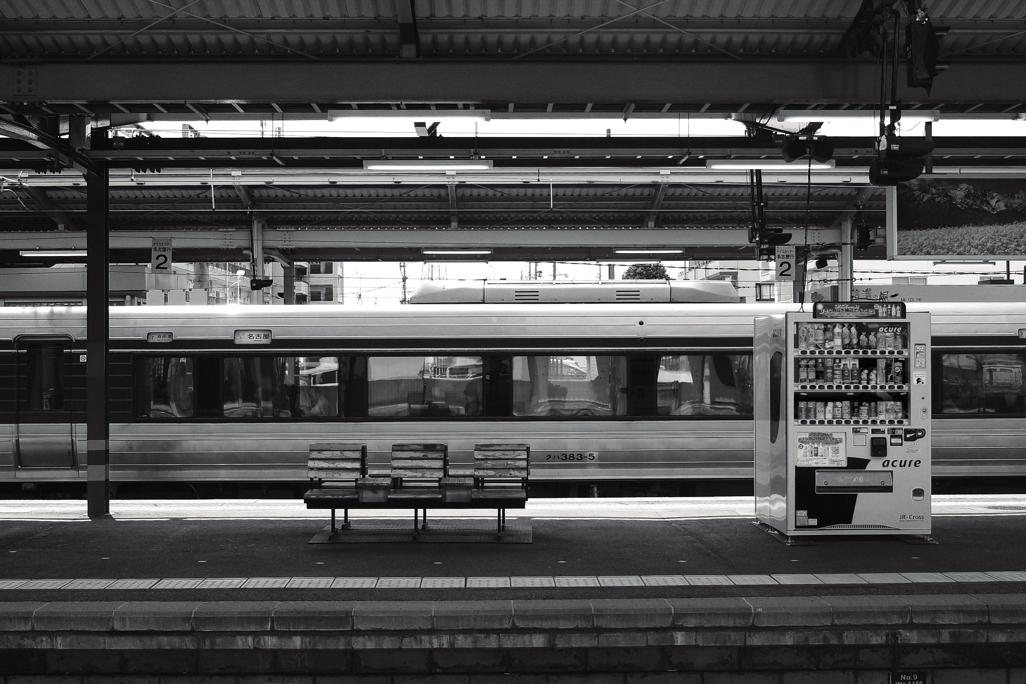 A traveler using a JR Pass ticket machine at a train station in Japan