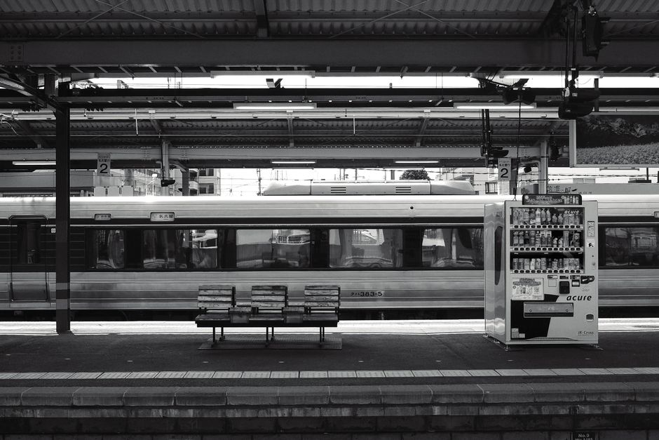 A traveler using a JR Pass ticket machine at a train station in Japan