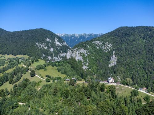 Free Aerial view of Măgura Village nestled in the Carpathian Mountains, Brașov, Romania on a sunny day. Stock Photo