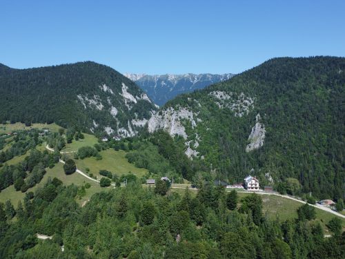 Free A stunning aerial shot of the lush green landscapes and distant mountains in Măgura, Brașov, Romania. Stock Photo