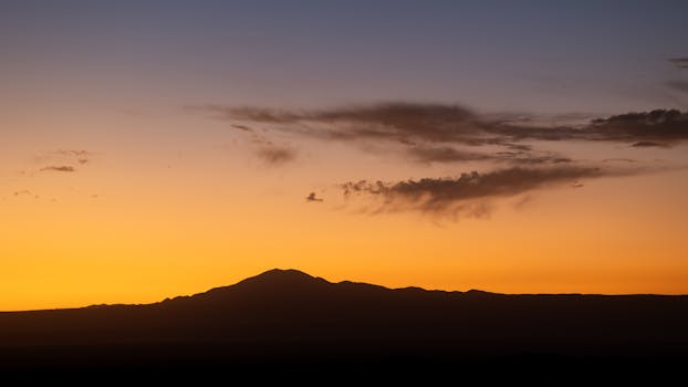 Breathtaking sunset over the Atacama Desert with vivid orange and purple hues.