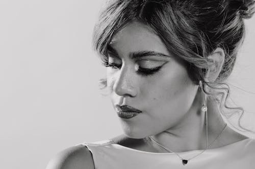 Sophisticated black and white portrait capturing a woman's thoughtful expression.