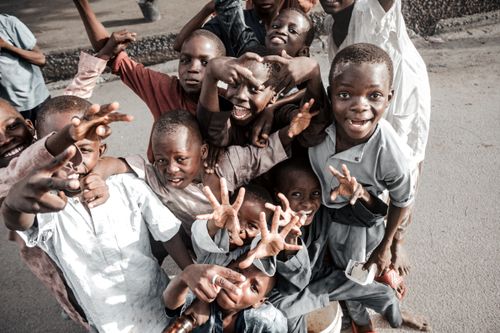 Free A vibrant group of children laughing and playing together outdoors, capturing the essence of joy and community. Stock Photo