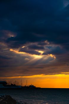 Stunning sunset over Yalova harbor with dramatic clouds and glowing sky.