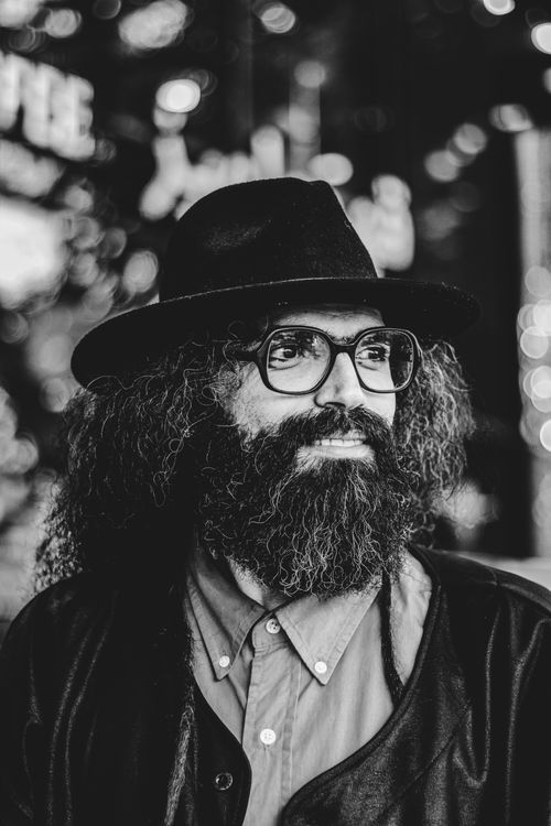 Free Artistic black and white portrait of a bearded man in Tehran, showcasing his unique style. Stock Photo