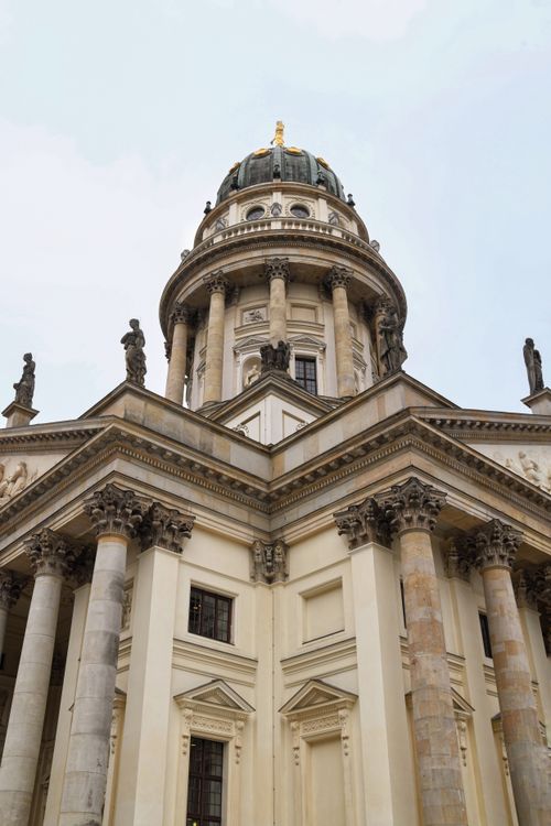 Free Upward view of Berlin's historic cathedral dome with classical architecture under a clear sky. Stock Photo