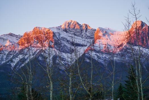 Breathtaking sunrise over the Canadian Rockies in Canmore, Alberta with snow-capped peaks.