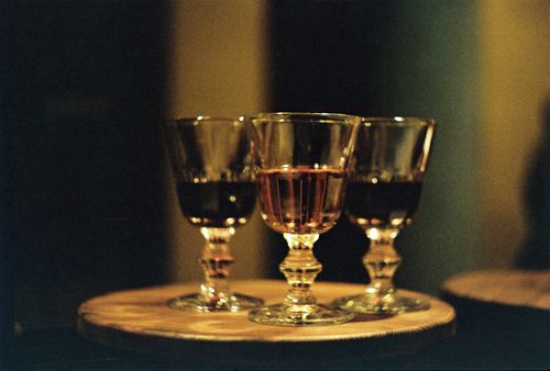 Free Three elegant wine glasses filled with red and pink wine creating a warm and inviting ambiance. Stock Photo