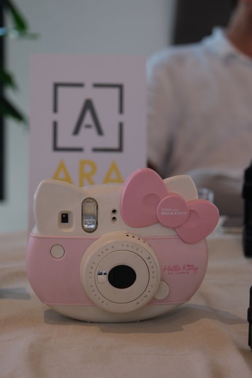 Free Pink Hello Kitty themed instant camera on a table indoors. Stock Photo