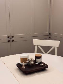 Stylish kitchen setup with candles and decor on a table for a warm ambiance.