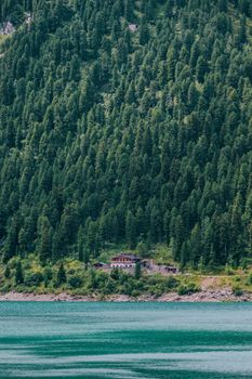Idyllic landscape of a forested mountain with a lake in Tirol, Austria.
