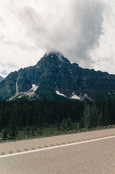 A towering mountain amidst lush forests in Jasper, Alberta, Canada.