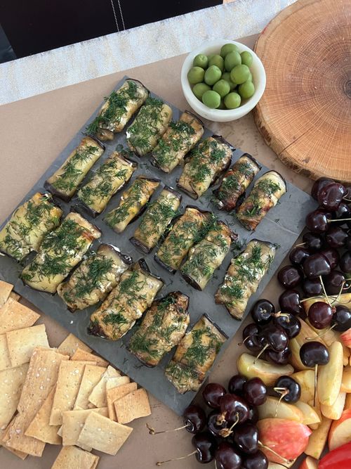 Free Elegant antipasto platter with olives, fruits, crackers, and rolled appetizers. Perfect for parties. Stock Photo