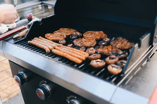 Grilled meat and mushrooms on a barbecue, perfect for a summer cookout.