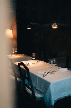 Warmly lit dining table in a cozy restaurant setting, perfect for intimate dinners.