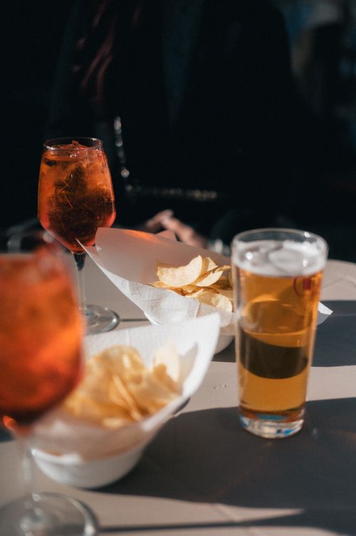 Free Beverages and snacks on a sunny table, highlighting relaxation and leisure. Stock Photo