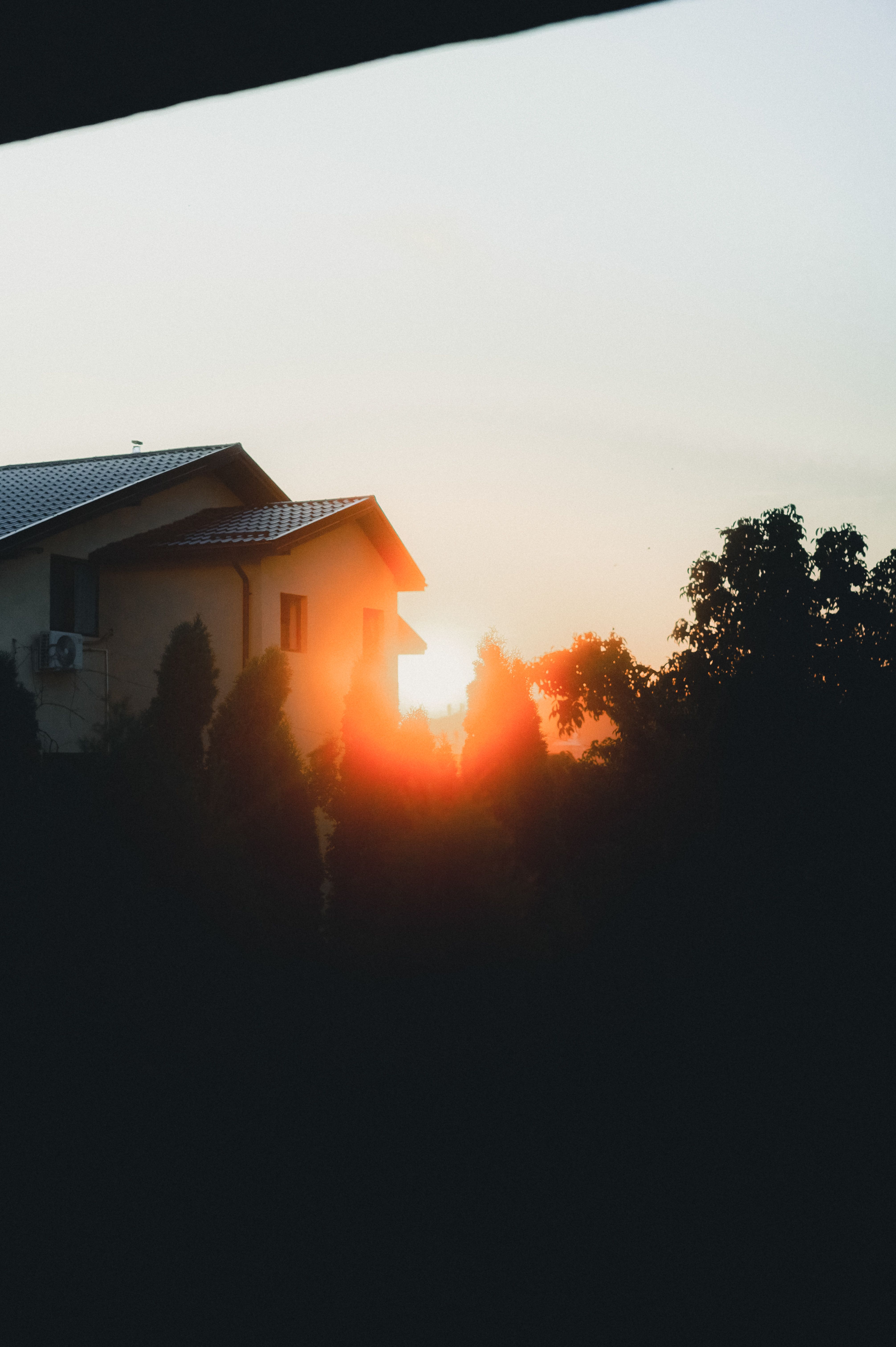 Serene Sunrise Over Suburban Home Silhouette · Free Stock Photo
