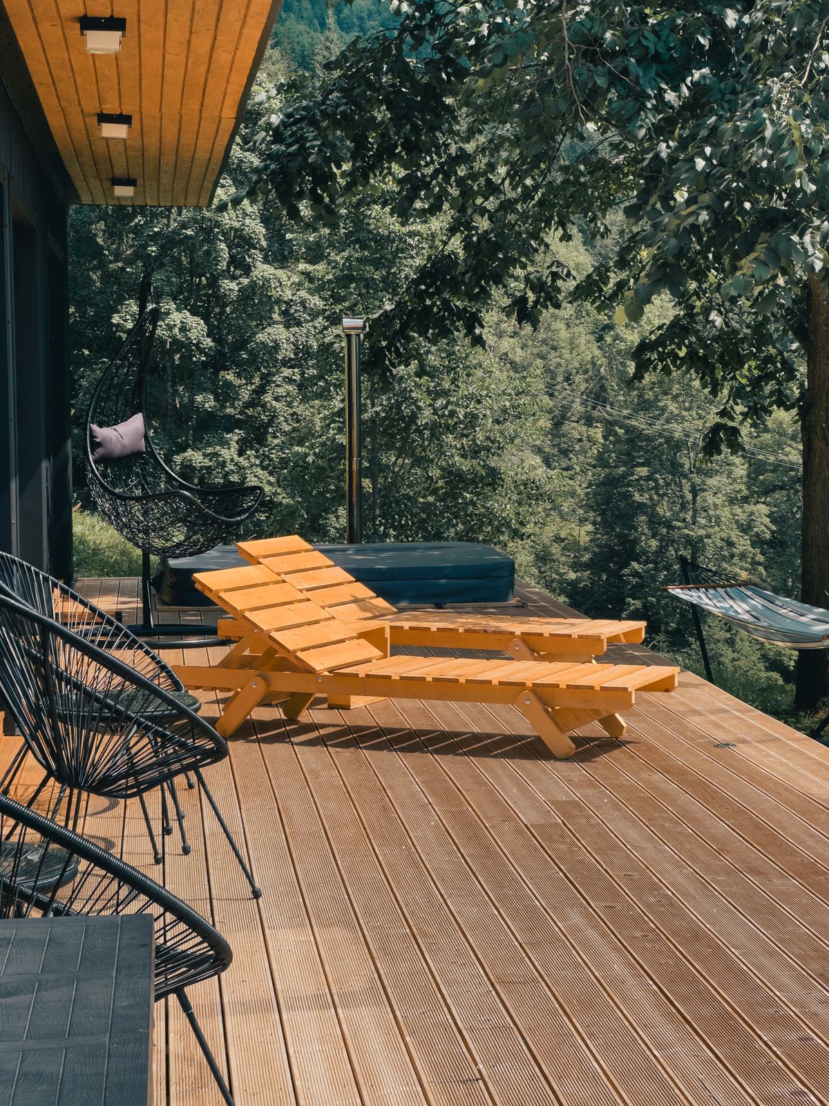 Wooden deck with lounge seating after exterior remodeling