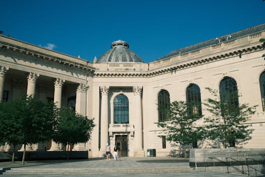 Elegant classical architecture of a historic library center under clear blue sky.