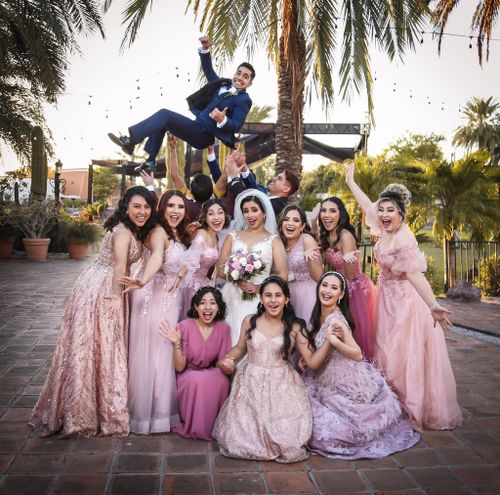 Free Vibrant outdoor wedding group with bridesmaids and groom in joyful moment. Stock Photo