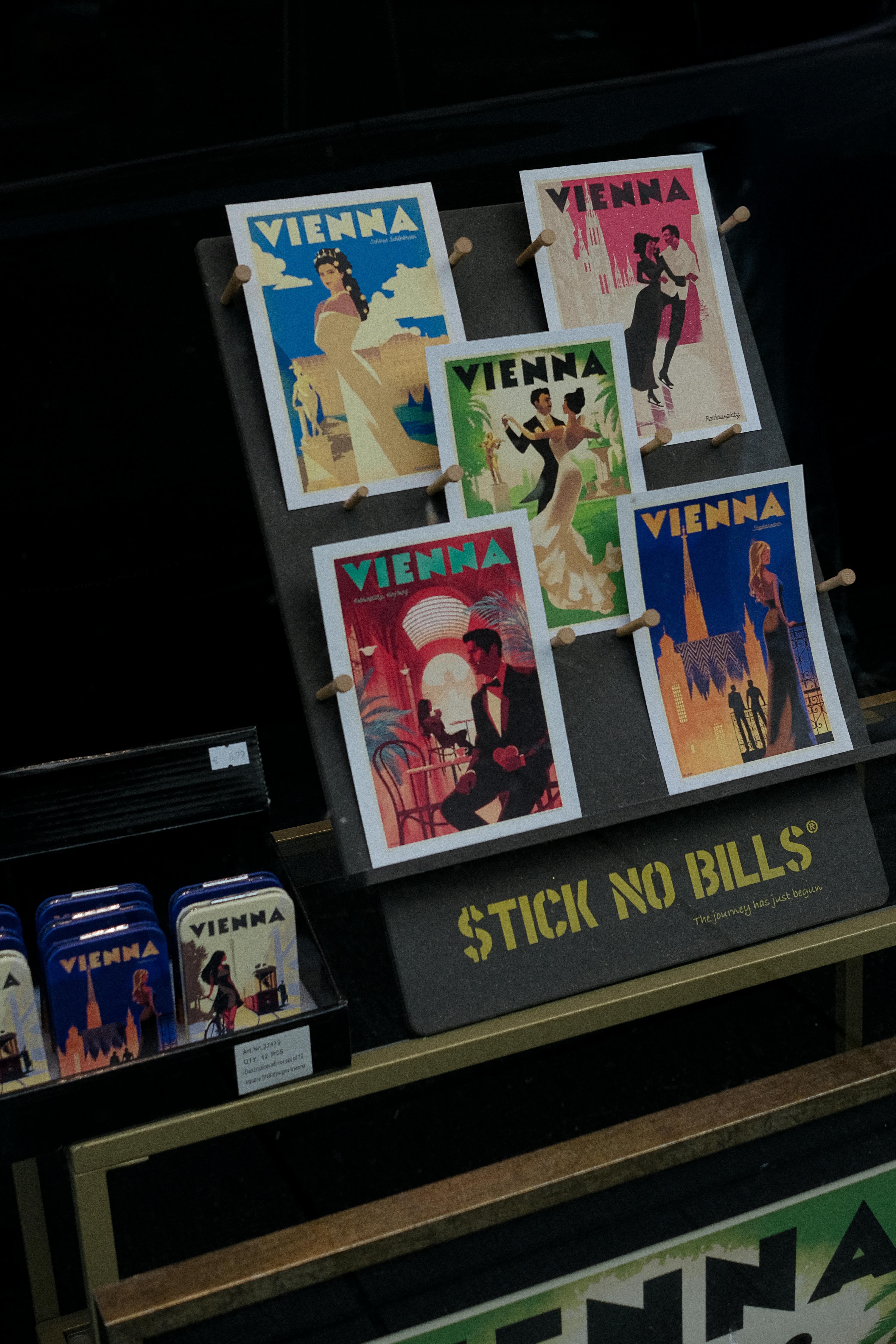 Colorful vintage-style Vienna posters on display in a street market.