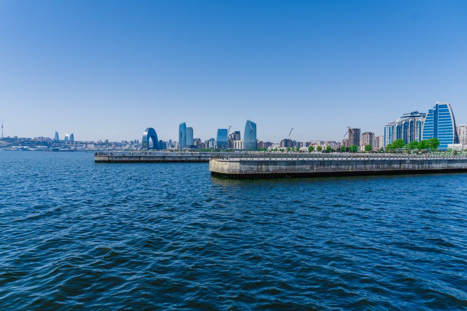 Stunning view of Baku's skyline from the Caspian Sea, featuring modern architecture and clear blue sky.