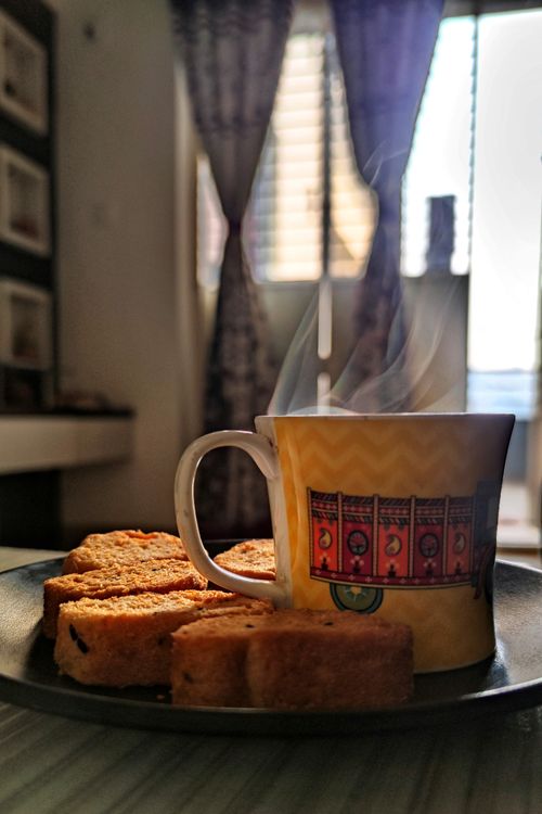 Free A warm cup of coffee with steam rising, accompanied by toast, in a cozy indoor setting. Stock Photo