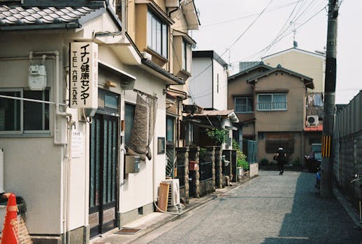 A narrow street in Japan featuring traditional architecture and buildings, capturing everyday life.