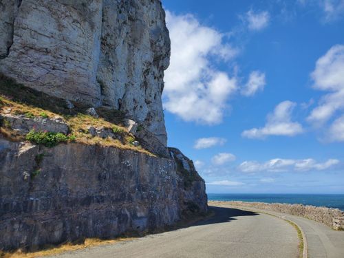 Free Explore the breathtaking cliffside road in Llandudno, Wales with stunning ocean views. Stock Photo