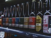 A selection of colorful craft beer bottles displayed on a shelf in a store in Almere, Netherlands.