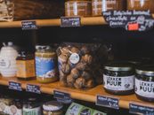Explore a vibrant Dutch store in Almere featuring local food items like walnuts, honey, and jams.