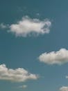 Serene Blue Sky with Fluffy White Clouds
