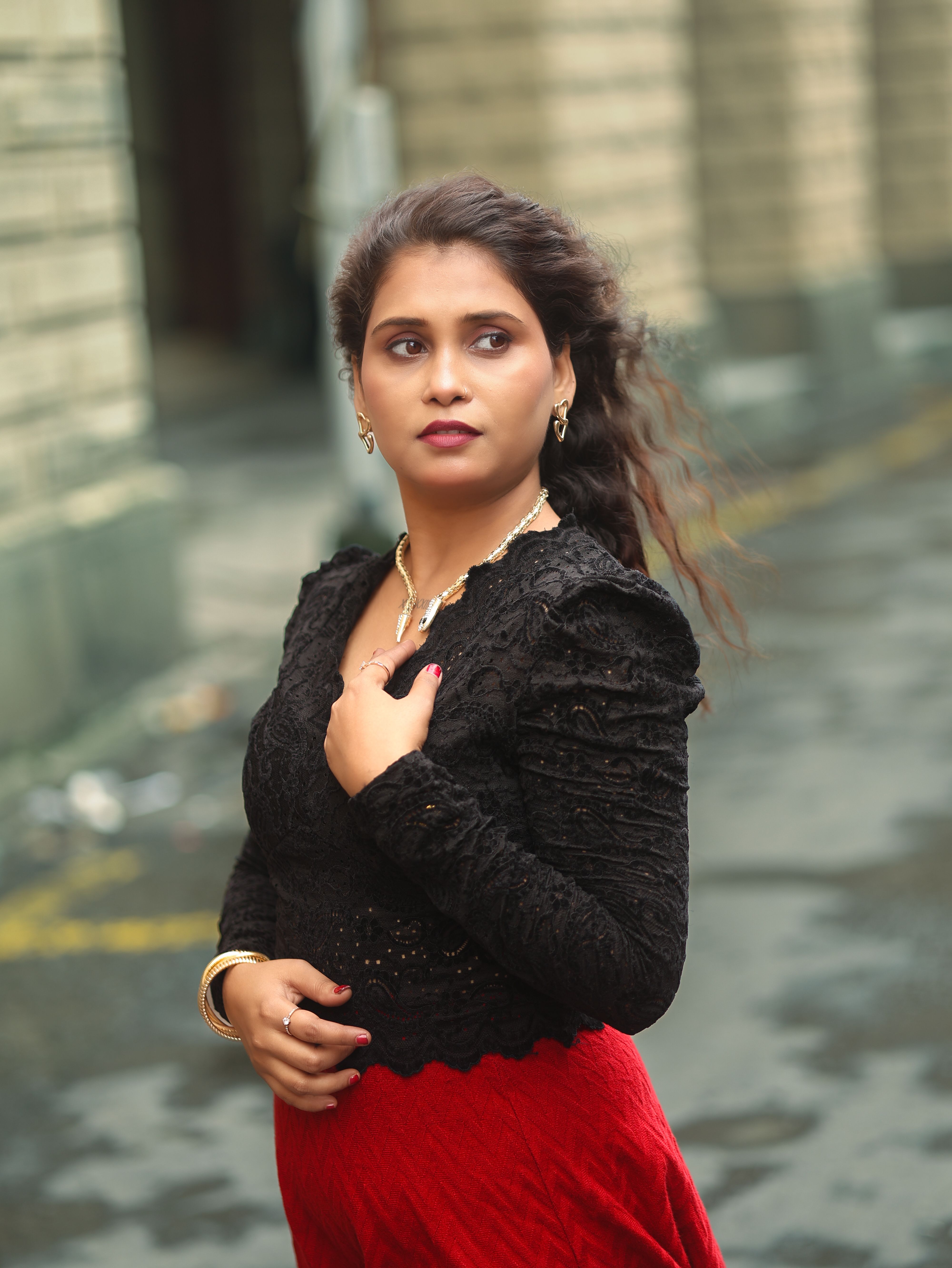 Elegant Woman Posing Outdoors in Urban Setting · Free Stock Photo