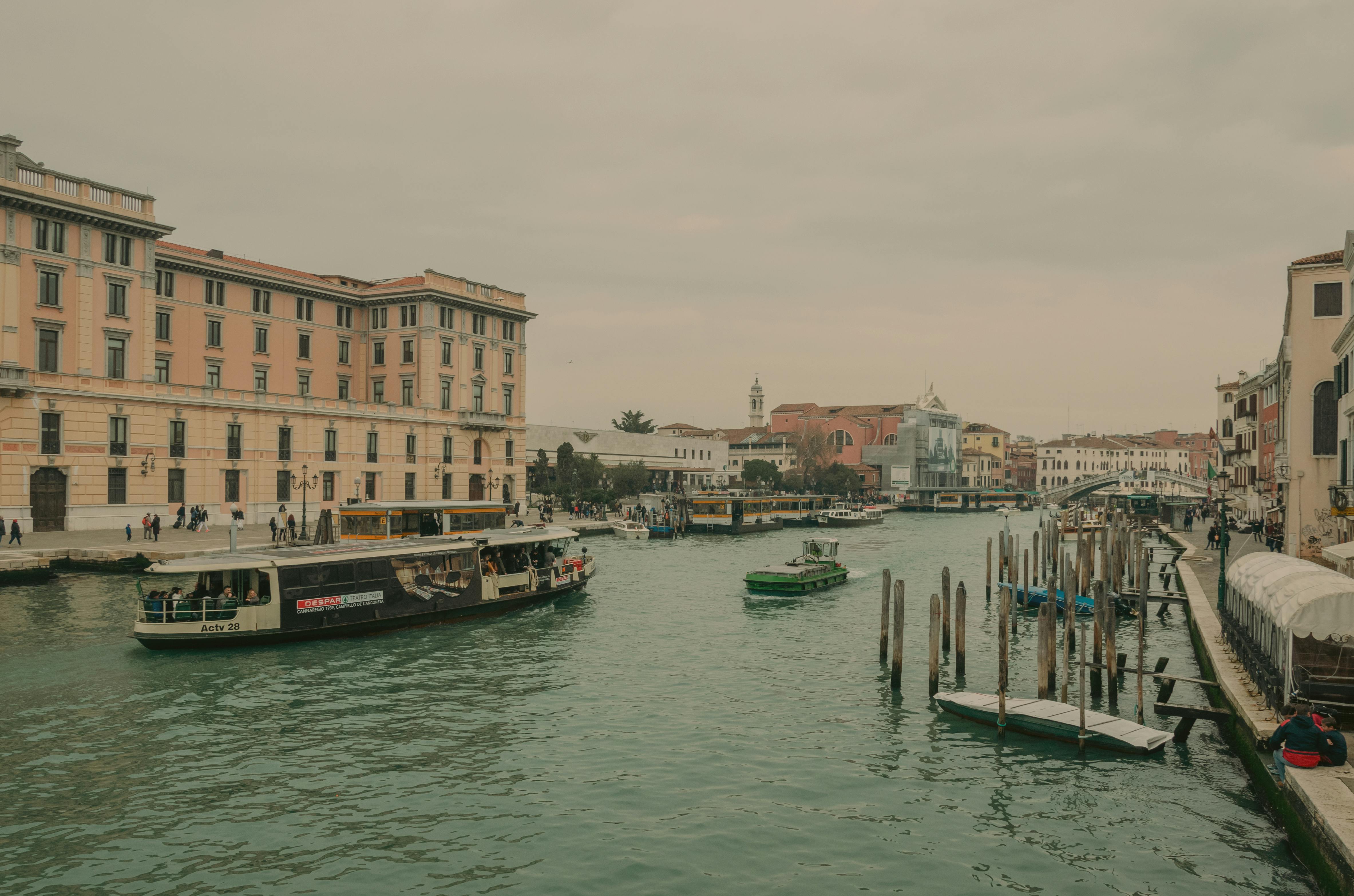 Explore the picturesque Venice Grand Canal with classic architecture and gondolas on a cloudy day.