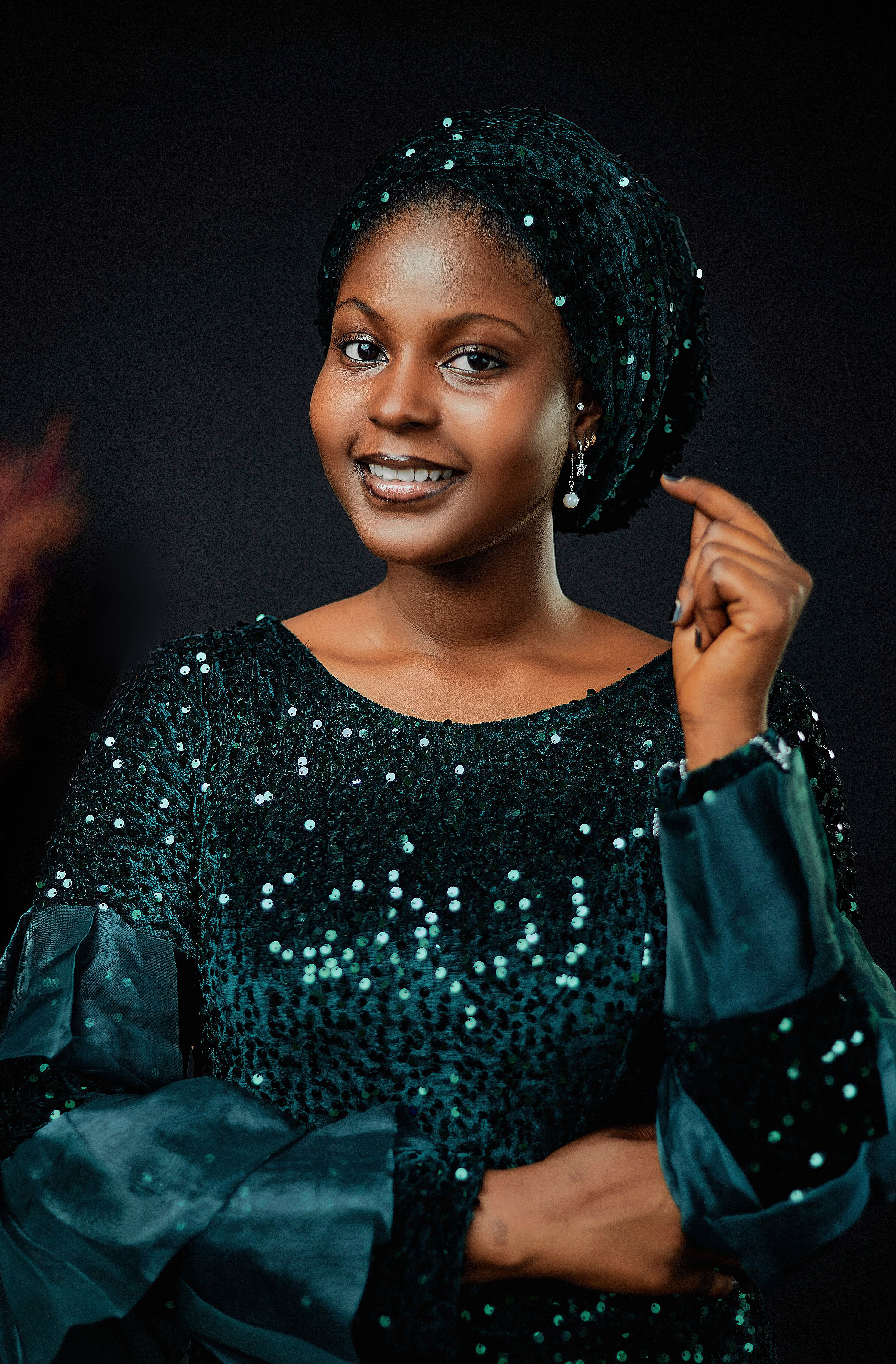 Elegant Portrait of a Smiling Woman in Sequin Dress · Free Stock Photo