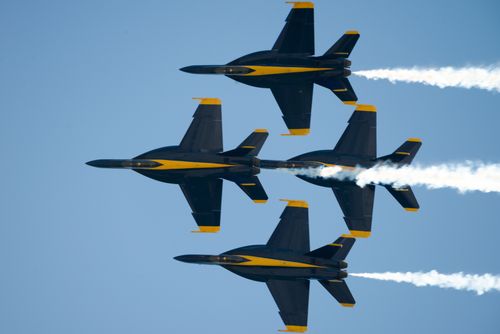 Free High-flying Blue Angels show precise aerobatic formations in clear blue skies. Stock Photo
