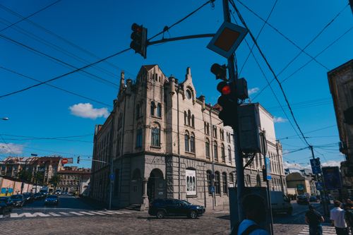 Free Charming historic building at a street intersection in Lviv, Ukraine, under a clear blue sky. Stock Photo