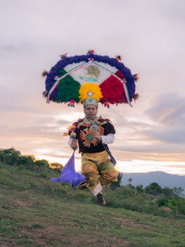 A dancer performs Danza de la Pluma against a stunning Oaxaca sunset backdrop.