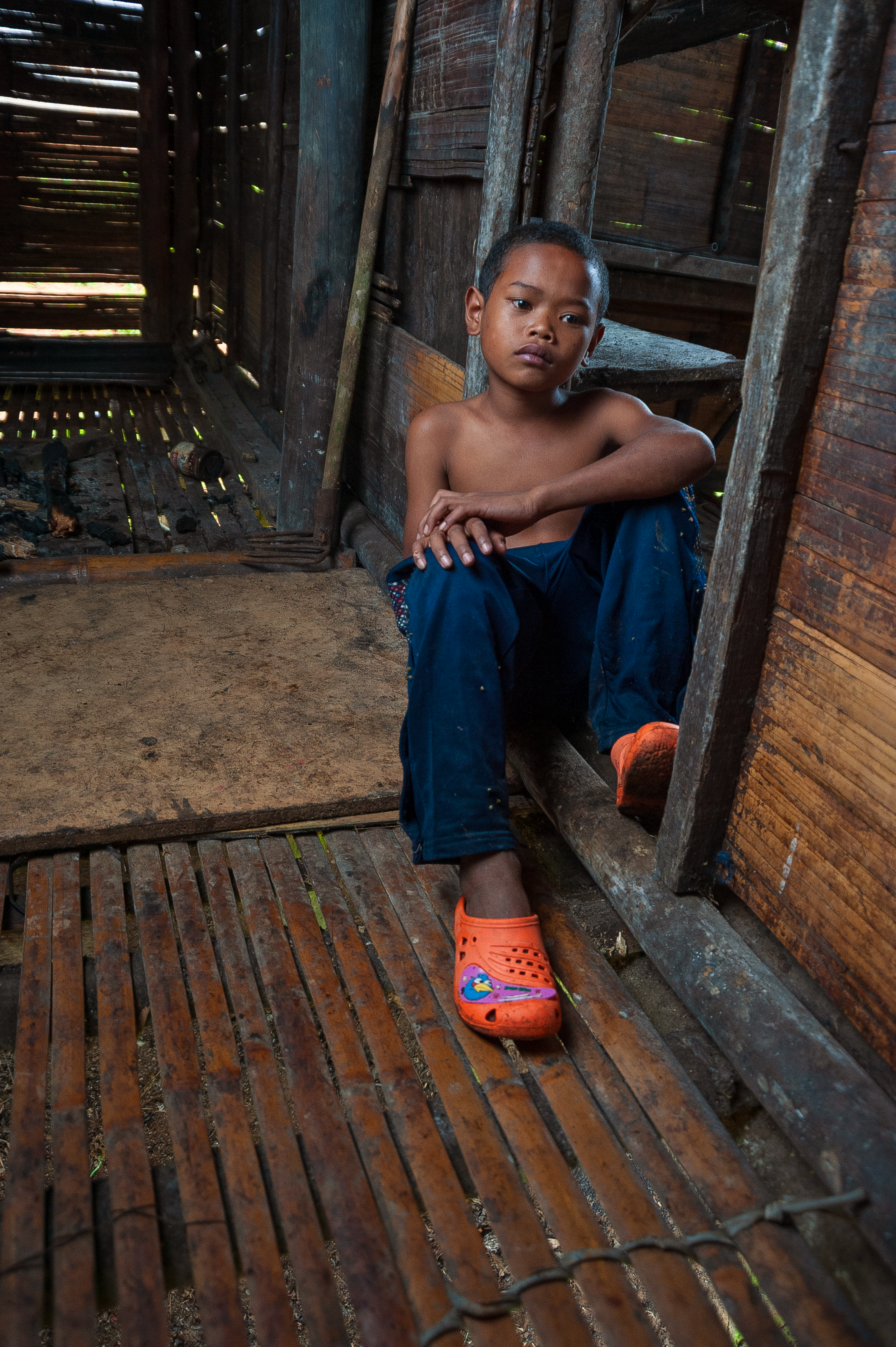 Pensive Child in Rustic Wooden House · Free Stock Photo