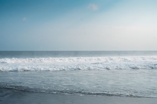 Free Peaceful ocean waves on a beach in the Special Region of Yogyakarta, Indonesia. Stock Photo