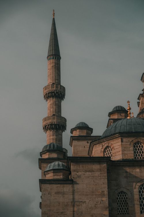 Free A serene view of an Ottoman-era mosque and its minaret under a moody sky in Istanbul, Turkey. Stock Photo