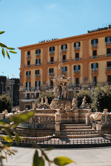 Explore Naples with this stunning view of a historic fountain against classic architecture in Italy.