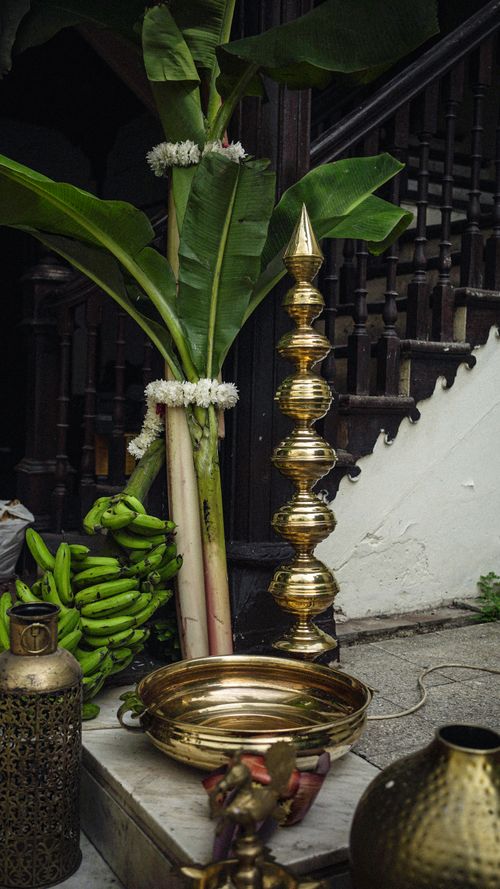 Free Traditional Indian decor featuring brass vessels, banana leaves, and lanterns in Ahmedabad. Stock Photo