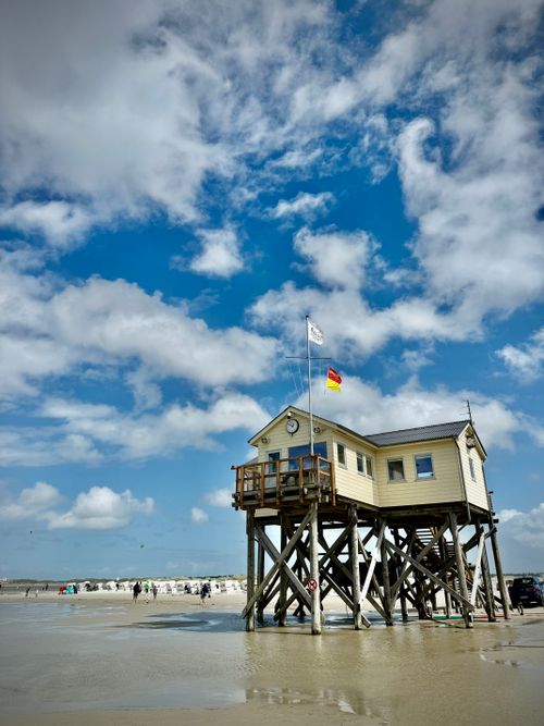 Free Stilt house on the sandy beach of Sankt Peter-Ording, Germany, under a blue sky. Stock Photo