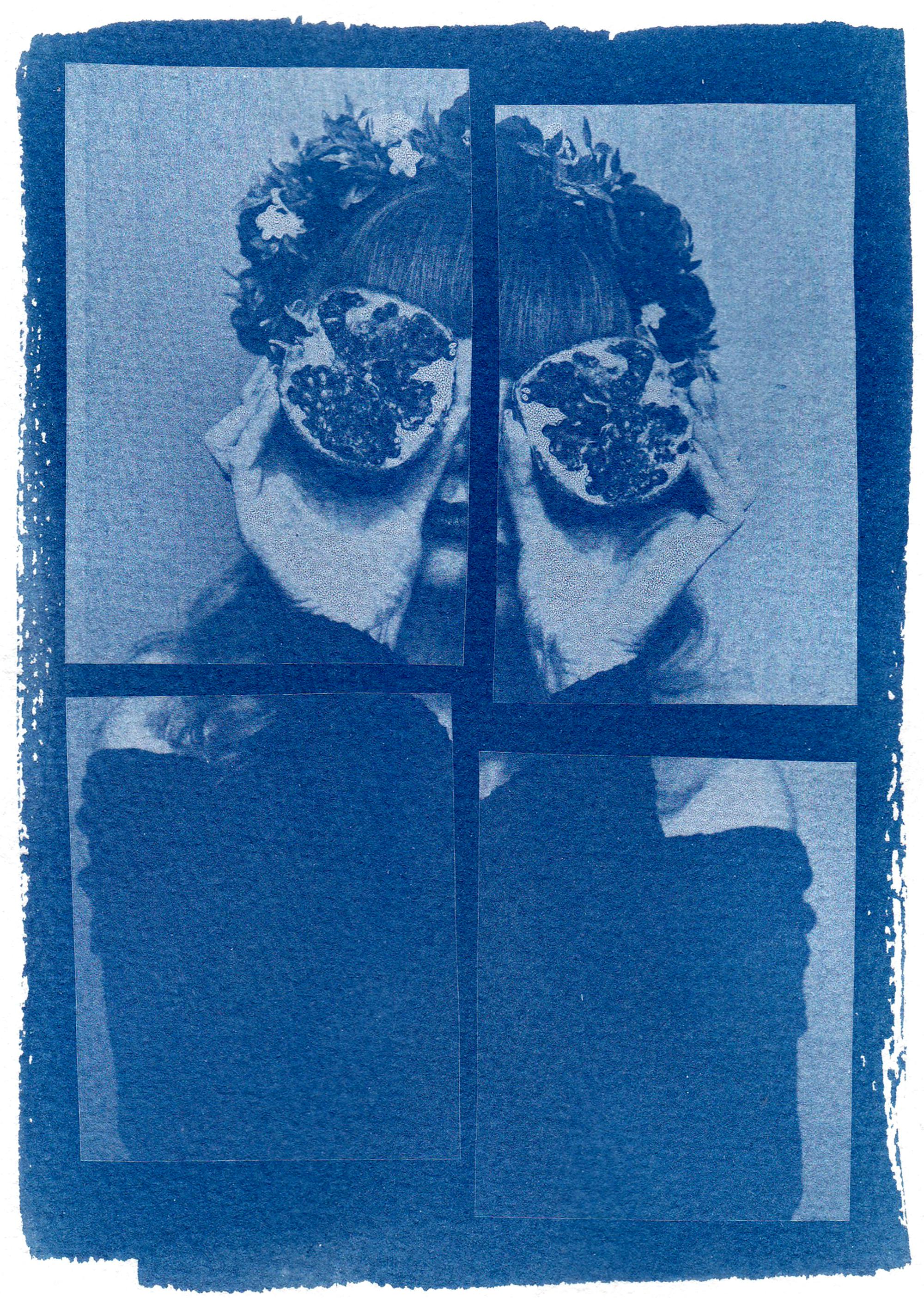 Vintage-style cyanotype of a person holding pomegranate halves over eyes.