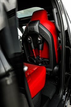 Close-up of a luxury car's red leather interior showcasing sleek and modern design.