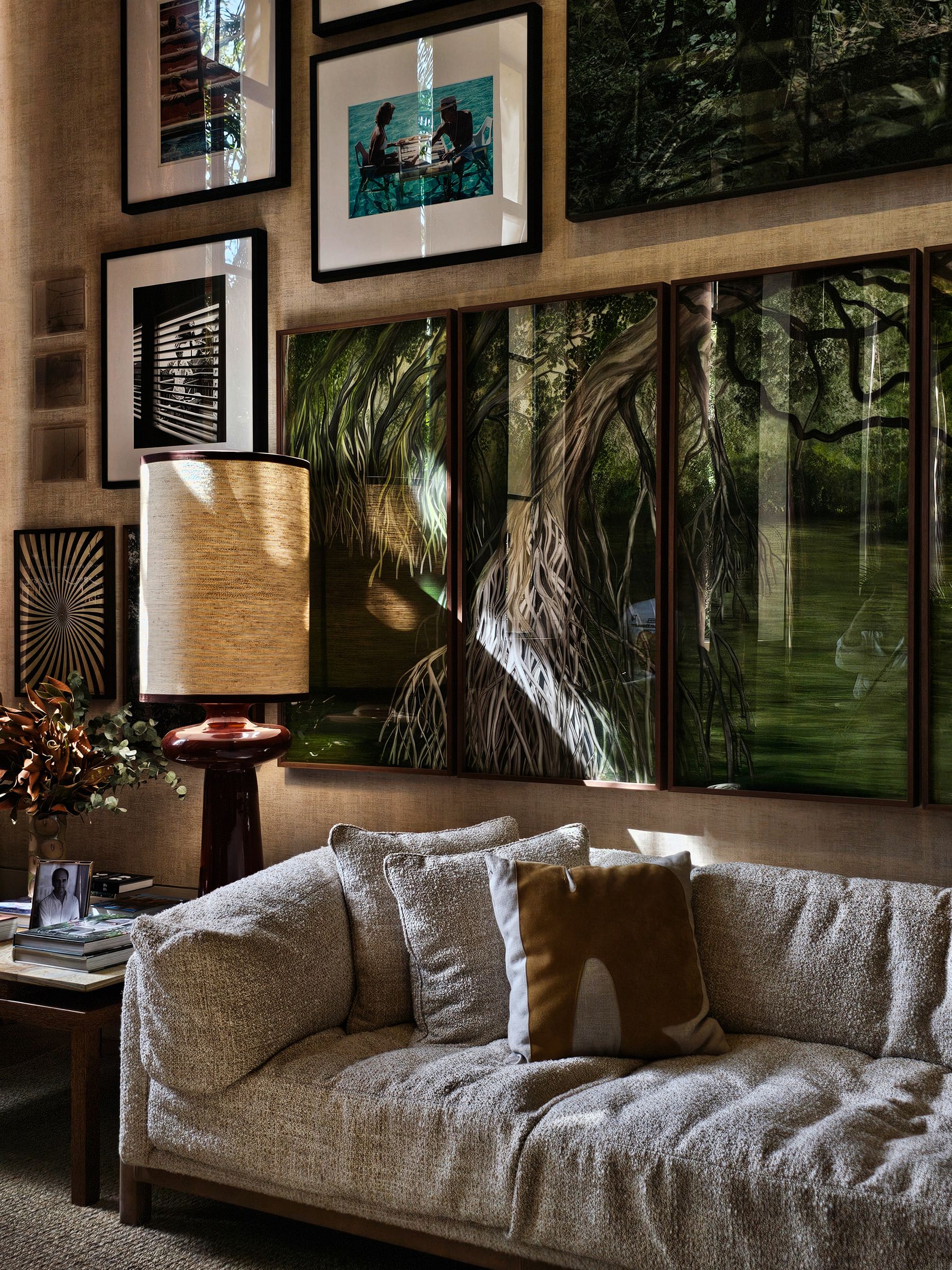 Gallery wall of varied framed photographs and nature images above a sofa