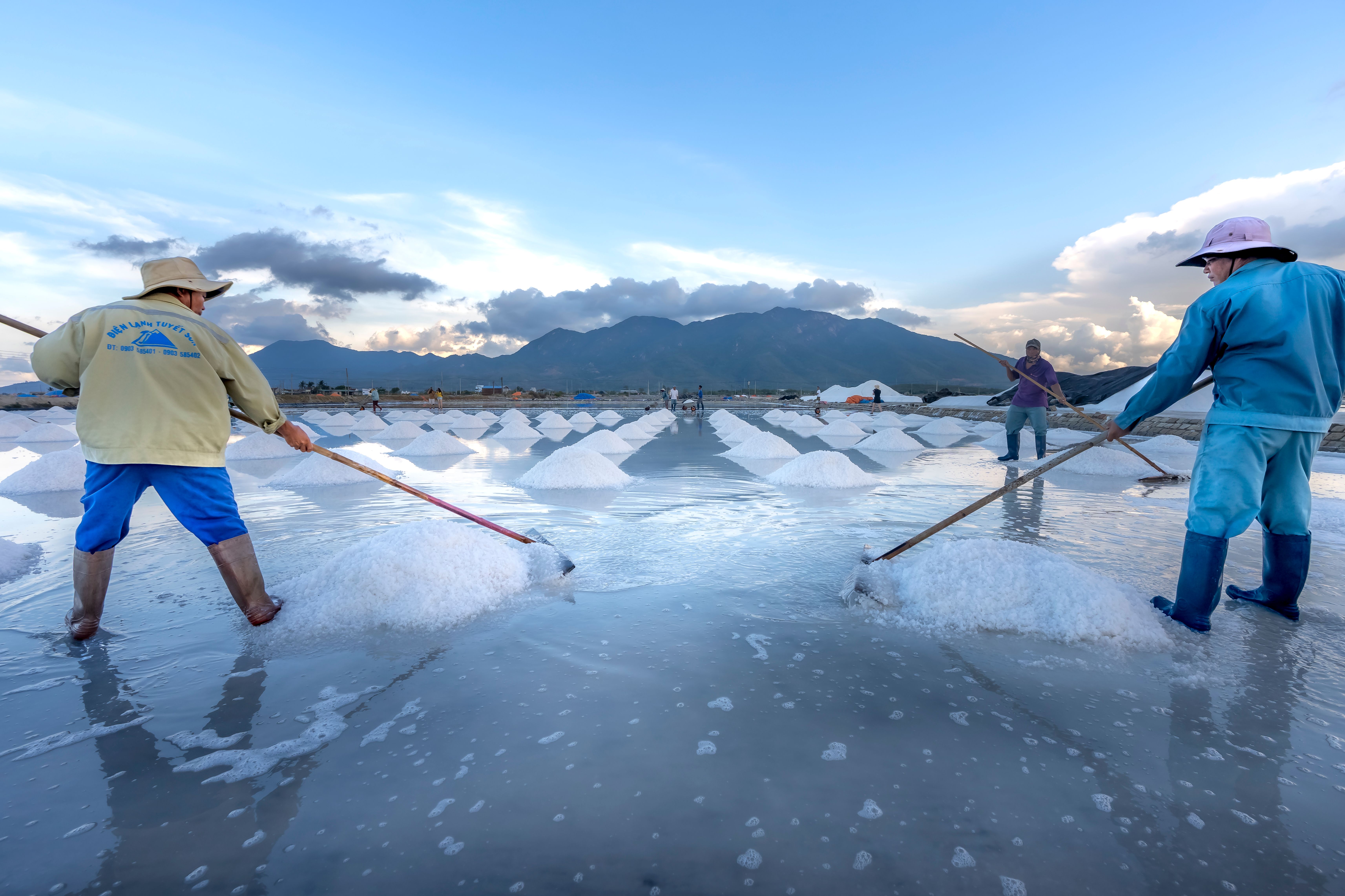 Workers Collecting Salt in Scenic Mountainside · Free Stock Photo