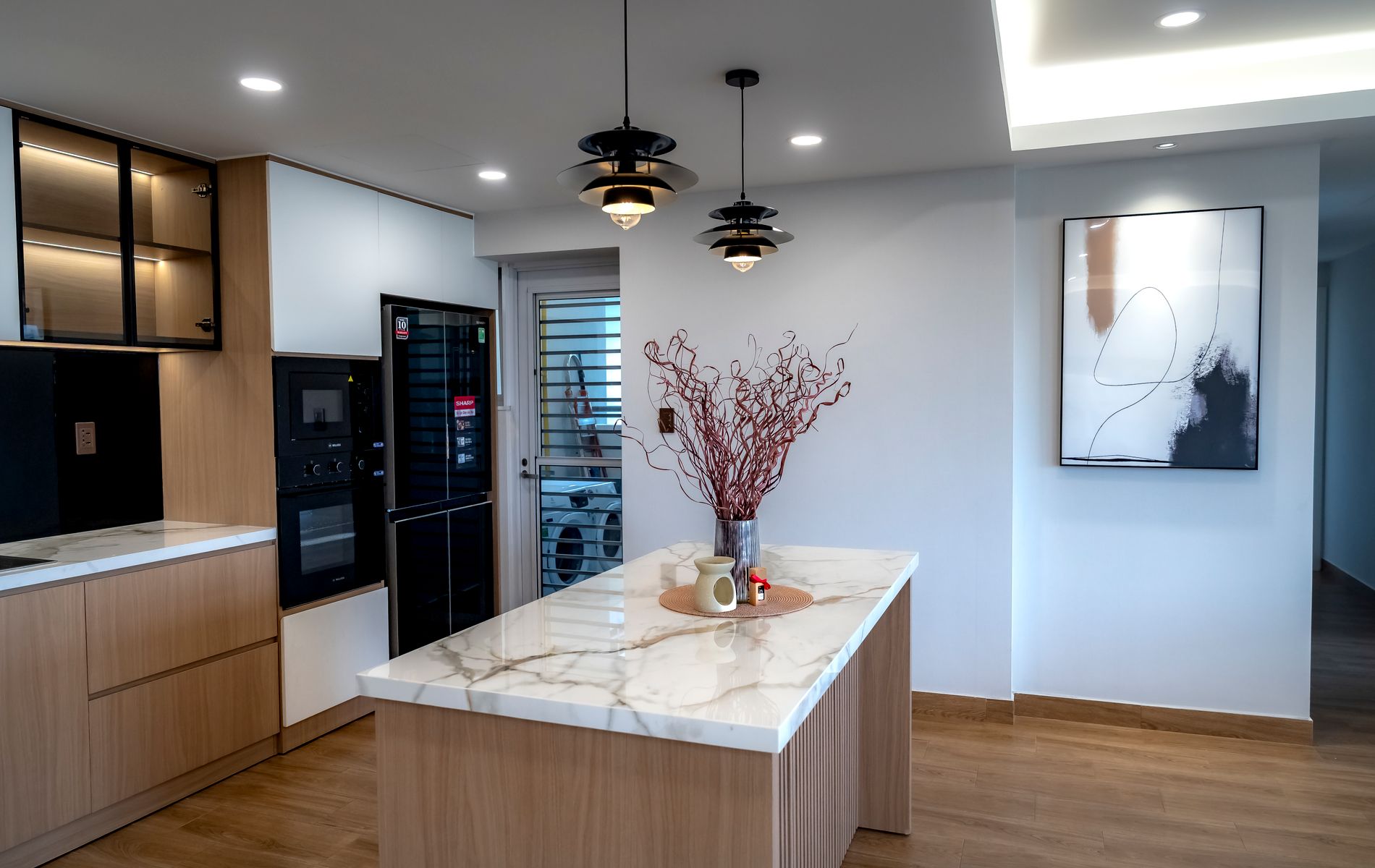 Modern kitchen lighting remodel with pendant fixtures over an island in Orange County