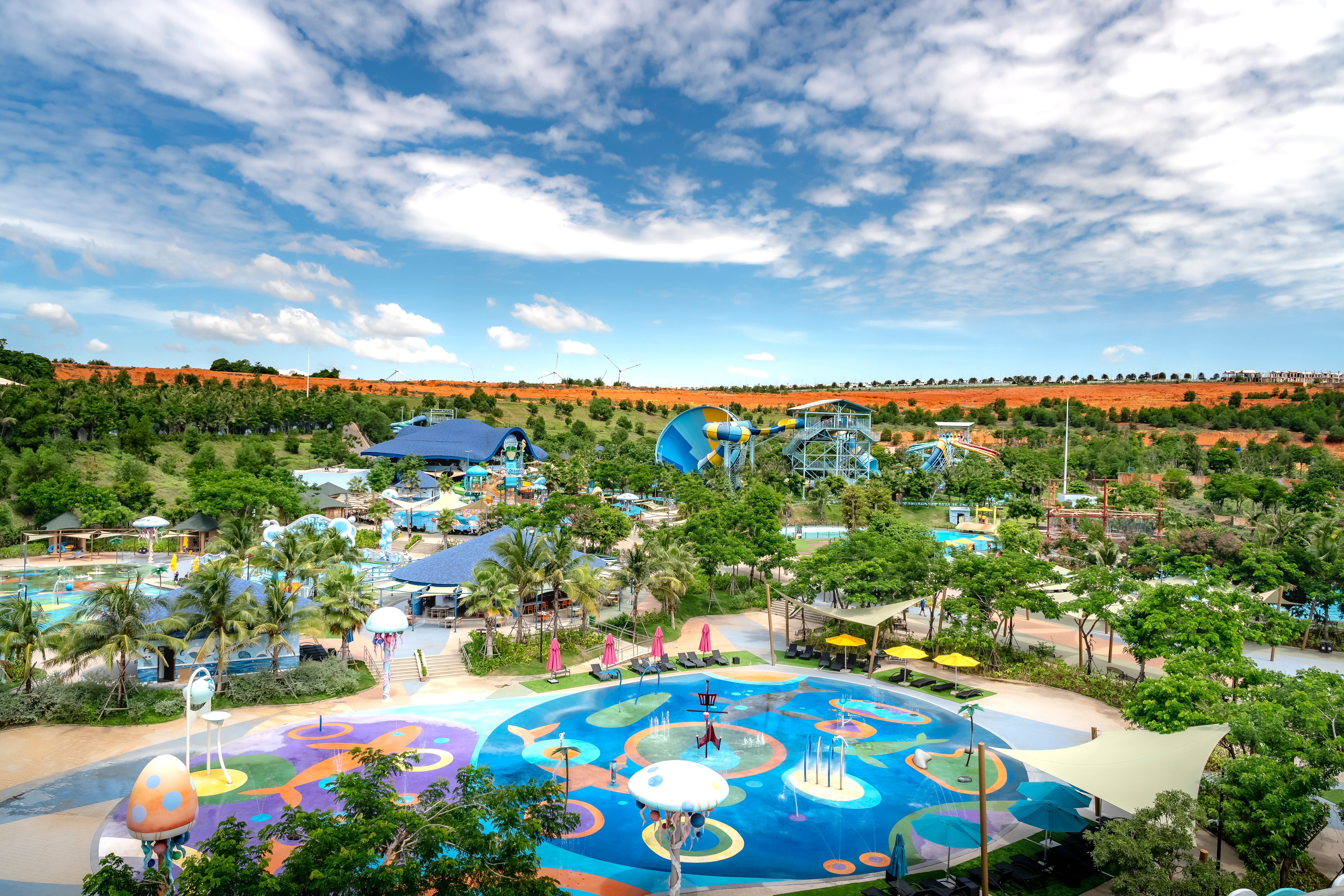 A colorful water park with slides and trees on a sunny day, perfect for family fun.